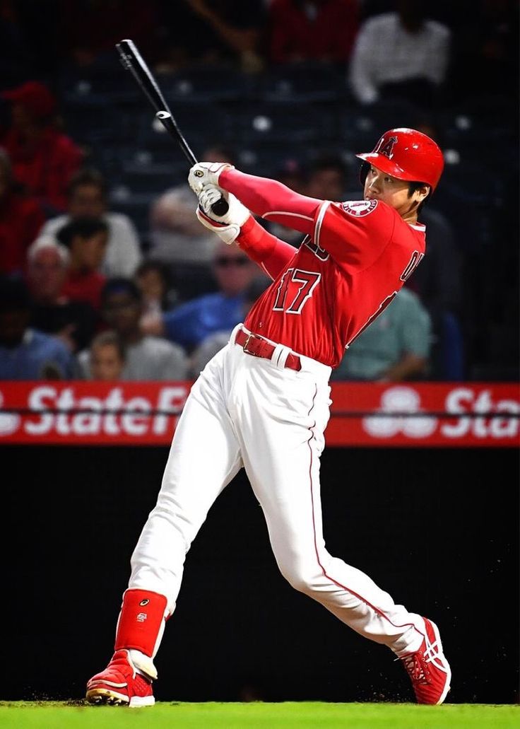 a baseball player is swinging his bat at the ball