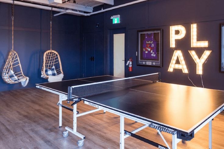 an indoor ping pong table in the middle of a room