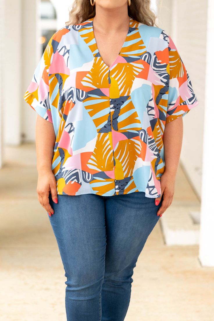 Elevate any casual wardrobe with this beautiful top! Featuring an abstract design in a vibrant blue hue, this top is sure to be your new favorite! Crafted from lightweight, breathable fabric, it ensures all-day comfort! This top is perfect for relaxed days at home or being paired with skinnies for a casual chic look! 100% Polyester Trendy Vacation Blouse With Abstract Print, Trendy Blouse With Abstract Print For Vacation, Trendy Abstract Print Blouse For Beach, Trendy Beach Blouse With Abstract Print, Trendy Tops With Bold Print For The Beach, Trendy Tops With Bold Print For Beach, Trendy Beach Top With Bold Print, Trendy Beach Tops With Bold Print, V-neck Beach Top With Abstract Print