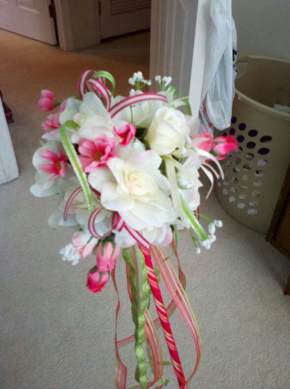 a vase filled with white and pink flowers