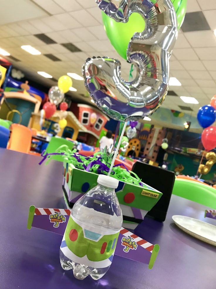 the balloon is in the shape of a number five and it's attached to a bottle