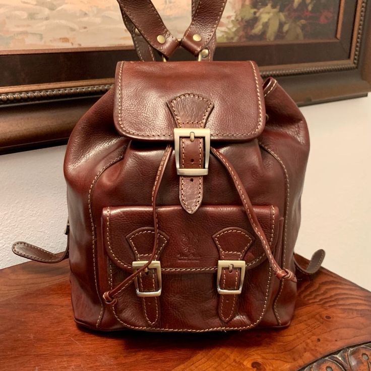 Genuine Leather Backpack By Vera Pelle, Made In Florence Italy The Genuine Italian Leather Crossbody Saddle Handbag Is Defined By It's Curved Shape And Finely Detailed Stitching. Perfect For Year-Round. Size, Large: 12” X 14 1/2” Adjustable Leather Straps Elegant Brown Backpack With Leather Backing, Luxury Backpack With Leather Handles For Daily Use, Luxury Brown Satchel Backpack, Elegant Leather School Backpack, Elegant Brown School Backpack, Designer Leather Backpack With Adjustable Strap For Daily Use, Luxury Leather Shoulder Backpack For School, Elegant Brown Leather Backpack For School, Designer Travel Backpack With Leather Lining