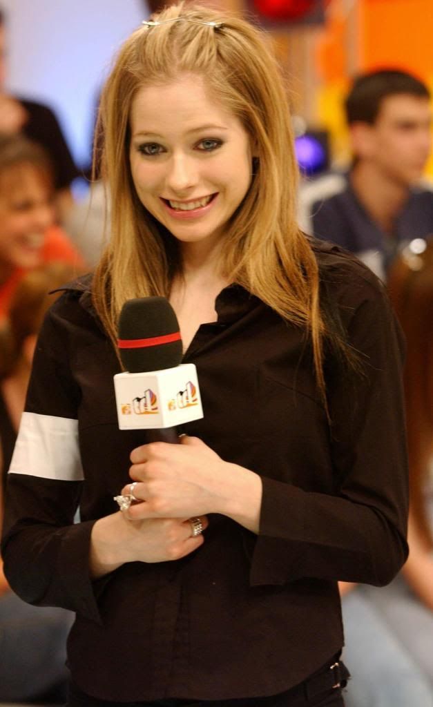 a woman holding a microphone in her hand