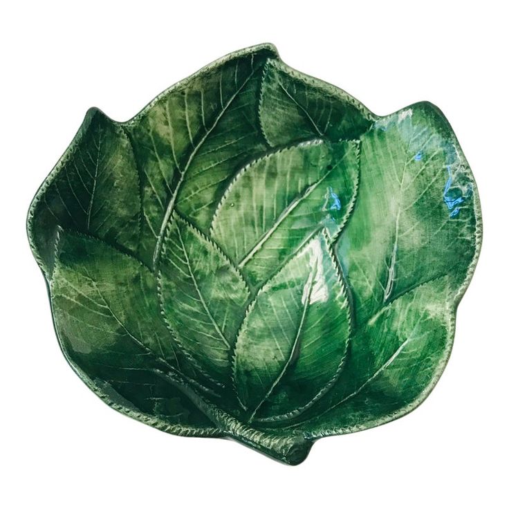 a green leaf shaped bowl on a white background