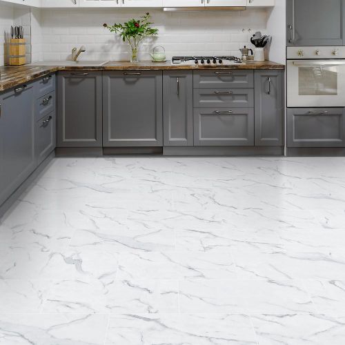 a kitchen with marble floors and gray cabinets