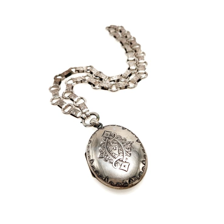 a silver necklace with a medallion on it