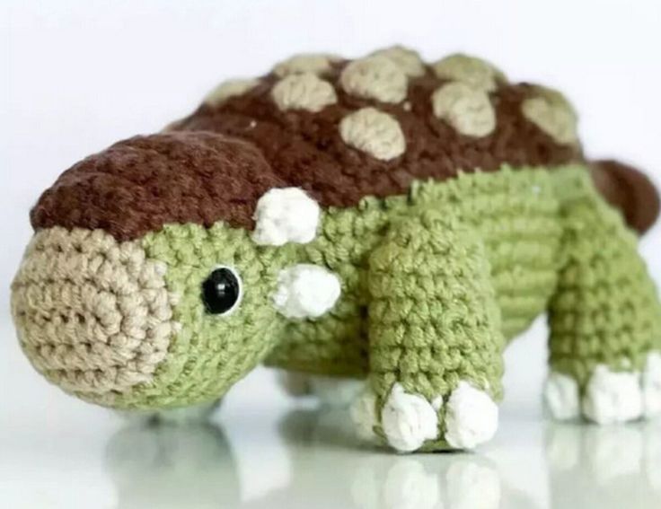 a crocheted turtle with white and brown dots on it's shell is shown