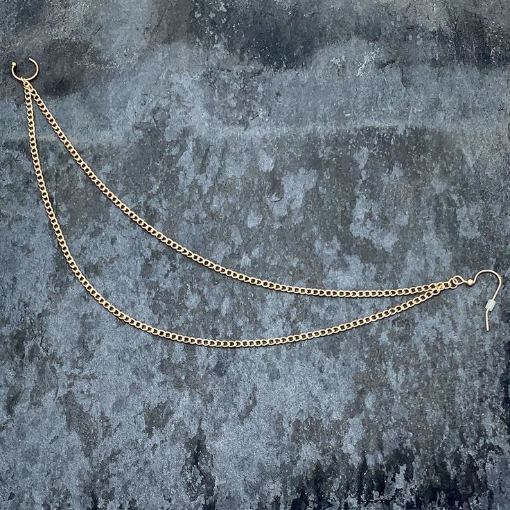 a gold chain is attached to a concrete surface