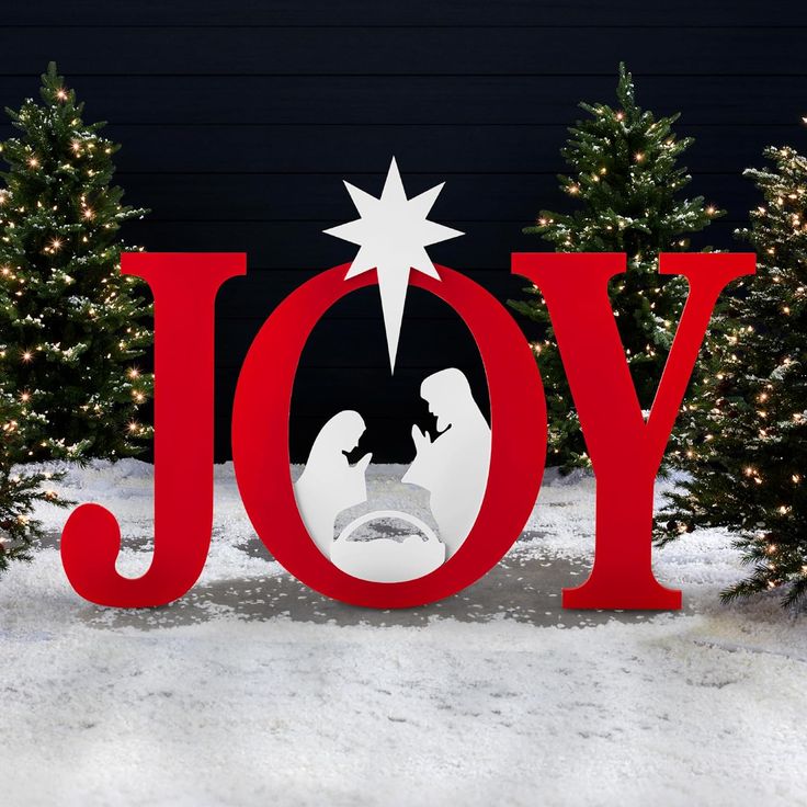 the word joy is displayed in front of christmas trees with a nativity scene on it