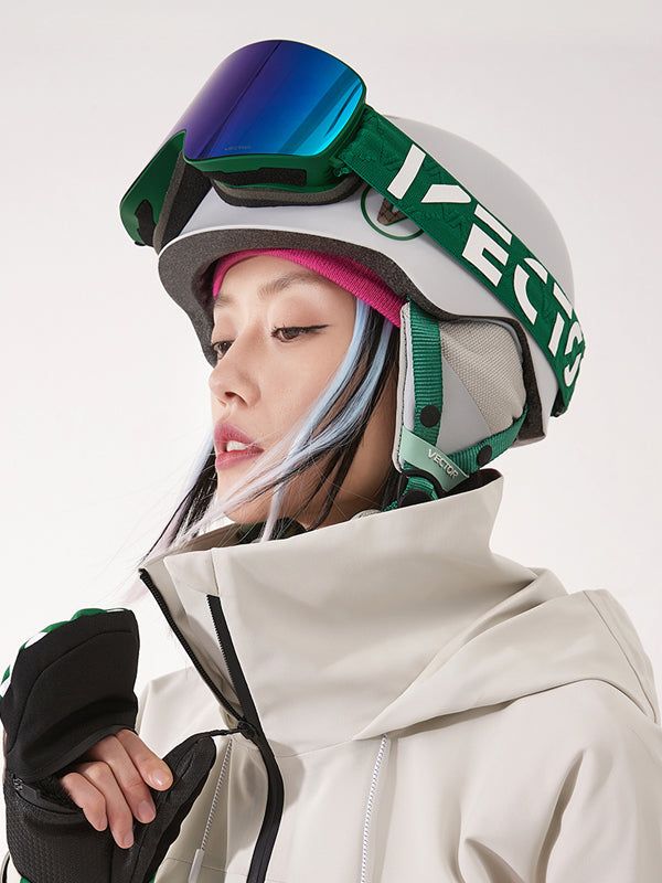 a woman wearing ski goggles and a white jacket