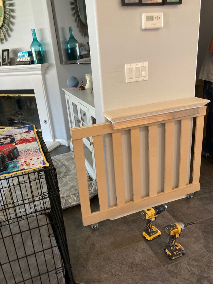 a room with a baby gate and some tools on the floor in front of it