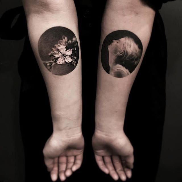 two people with matching tattoos on their arms