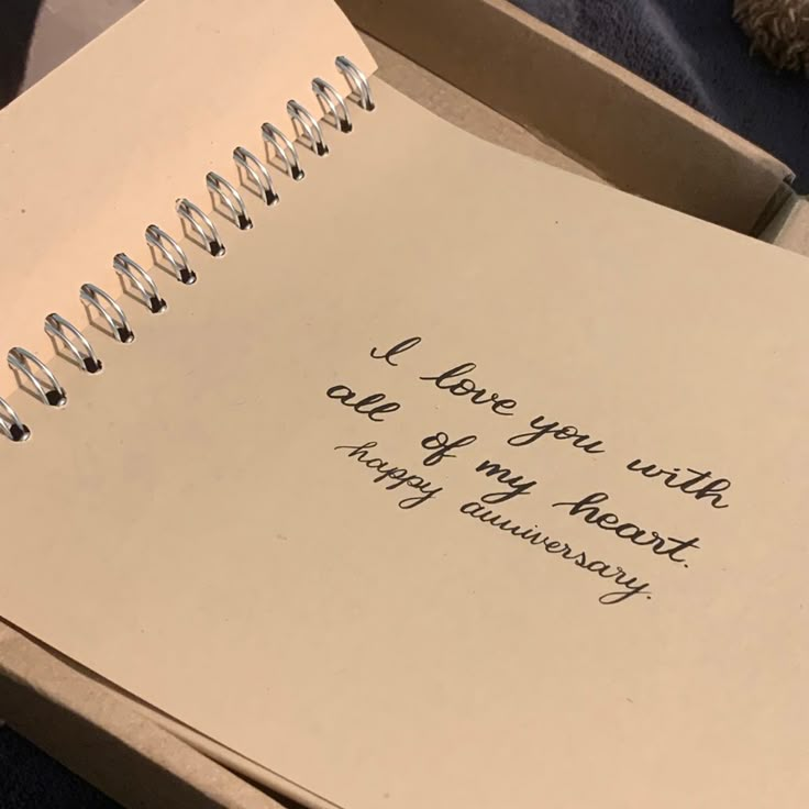 an open notebook with the words i love you with care of my heart and anniversary written on it