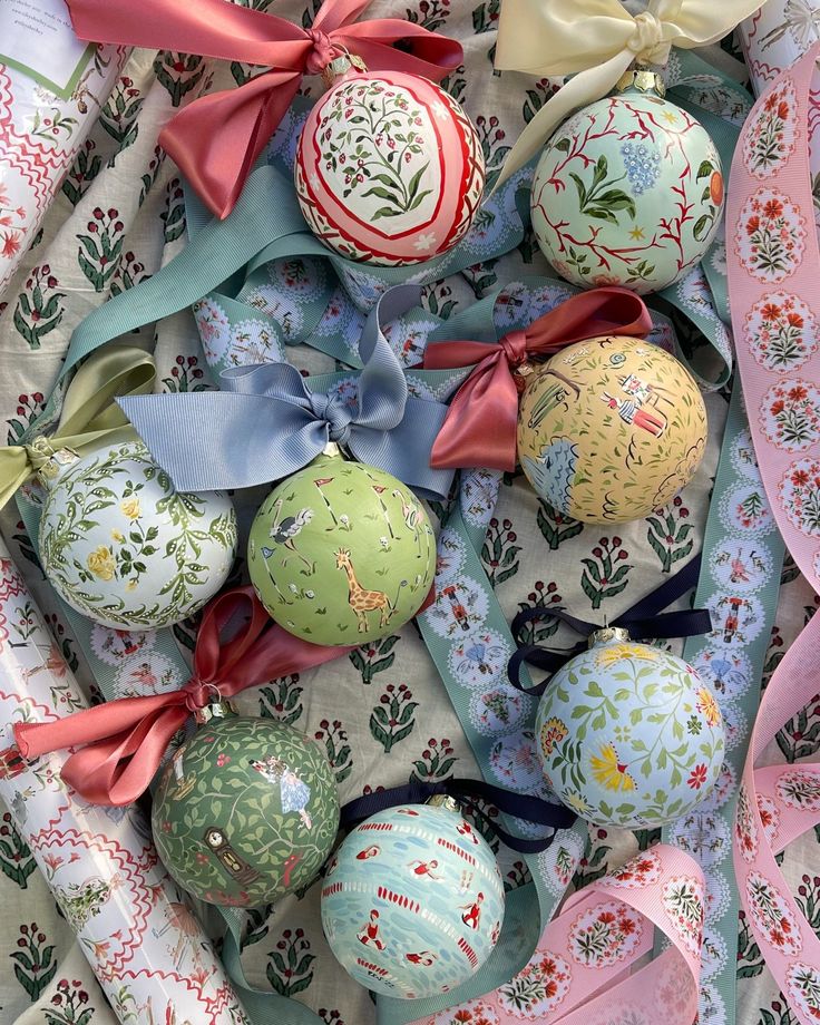 an assortment of decorated christmas balls with ribbons