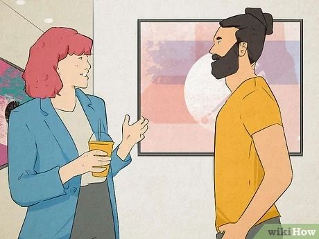 a man and woman talking in an art gallery