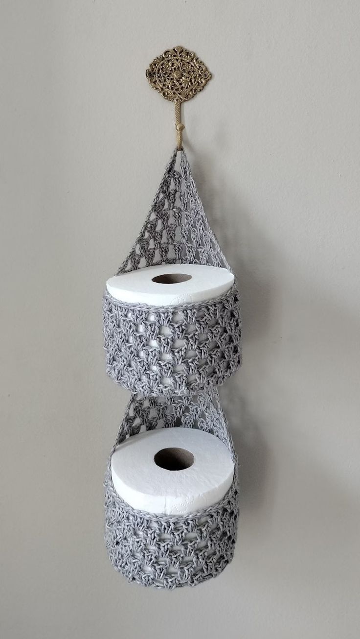 two rolls of toilet paper are hanging on the wall