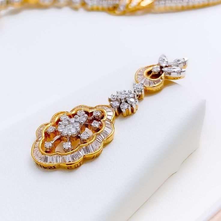 This exquisite 18k gold set, weighing 46.8 grams, features an extravagant floral vine design adorned with dazzling diamonds. The yellow gold finish enhances its luxurious appeal, making it perfect for any special occasion. The set includes a necklace with a total diamond weight of 8.16 carats, featuring F-G color and VS quality diamonds in round and baguette shapes. The necklace has a length of 16.5 inches with a 1.5-inch drop length, adjustable 0.75-inch links, and a secure hook lock. The match Exquisite Gold Bridal Necklace Hand Set, Exquisite Gold Bridal Necklace With Cubic Zirconia, Luxury Yellow Gold Bridal Necklace As Gift, Elegant Gold Plated Bridal Necklace For Anniversary, Gold Diamond Hand-set Bridal Necklace, Gold Diamond Hand Set Bridal Necklace, Gold Hand Set Diamond Bridal Necklace, Hand Set Gold Diamond Bridal Necklace, Gold Bridal Necklace With Diamonds Hand Set