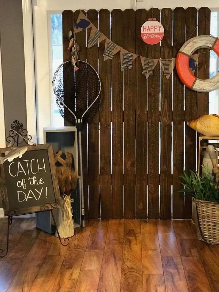 a room with wooden flooring and various items on the wall that say catch your day