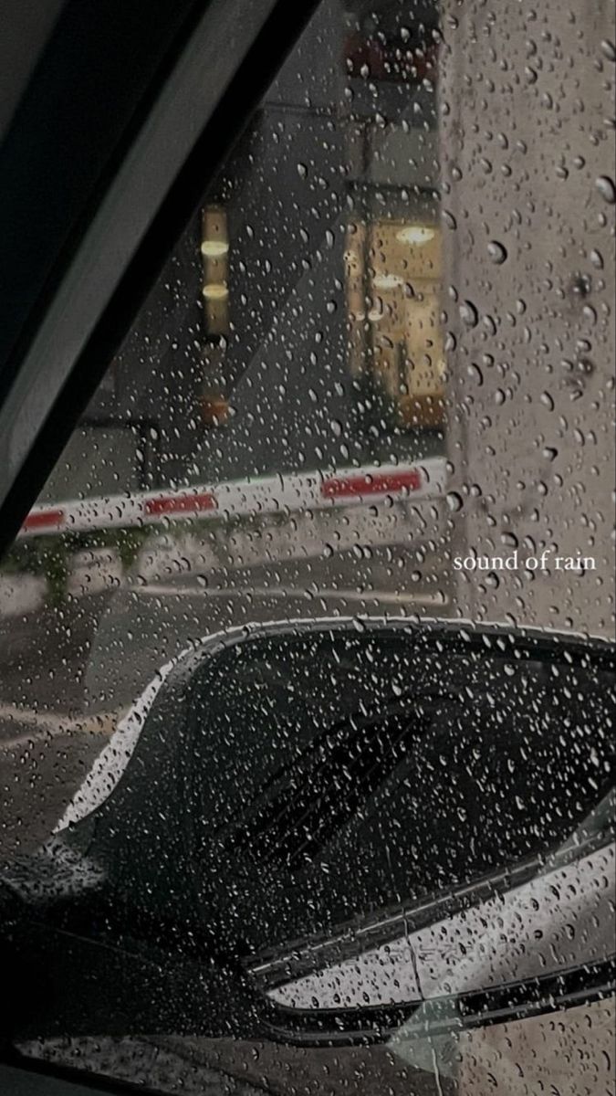 rain drops on the side mirror of a car