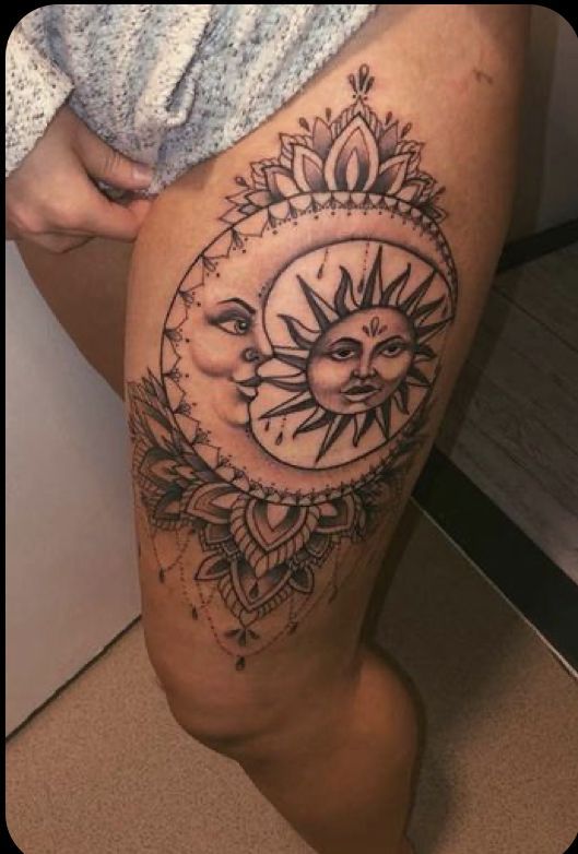 a woman's thigh with a sun and moon tattoo on it