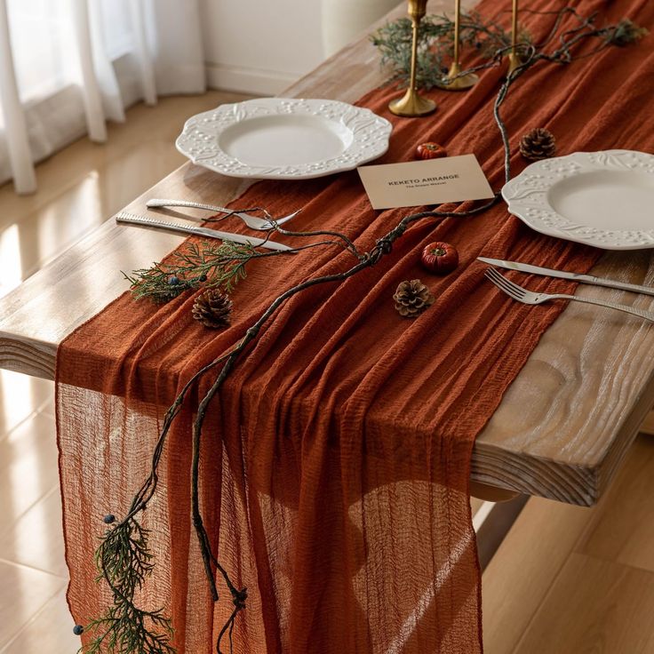 the table is set with plates and place settings