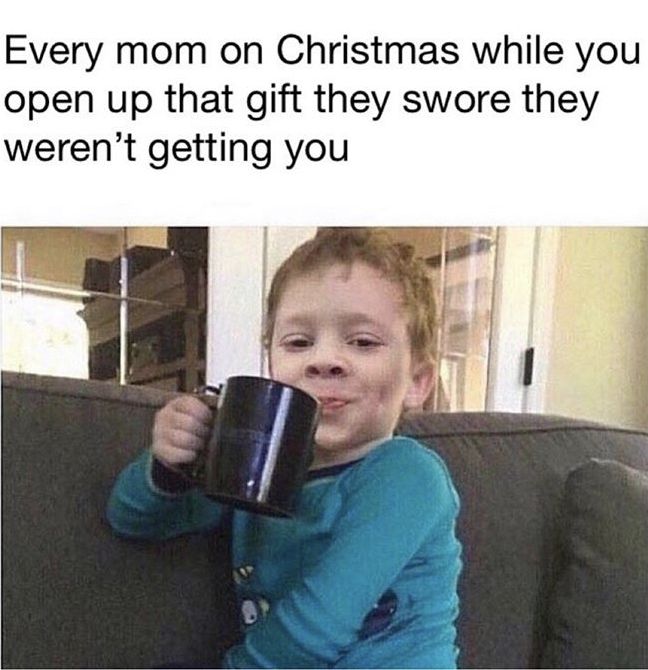 a little boy holding a coffee mug while sitting on top of a couch with the caption, every mom on christmas while you open up that they're getting you