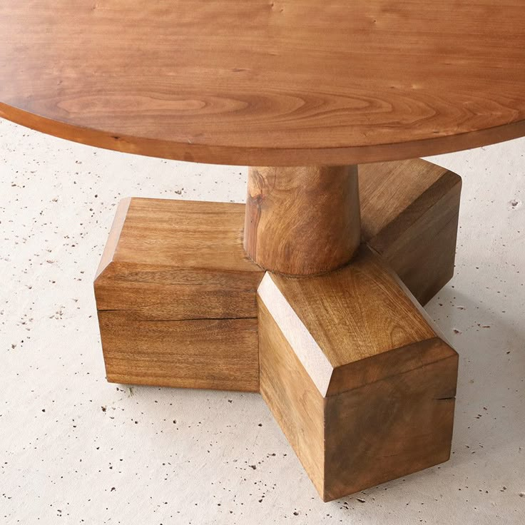 a wooden table that has been made out of wood blocks and is sitting on the floor