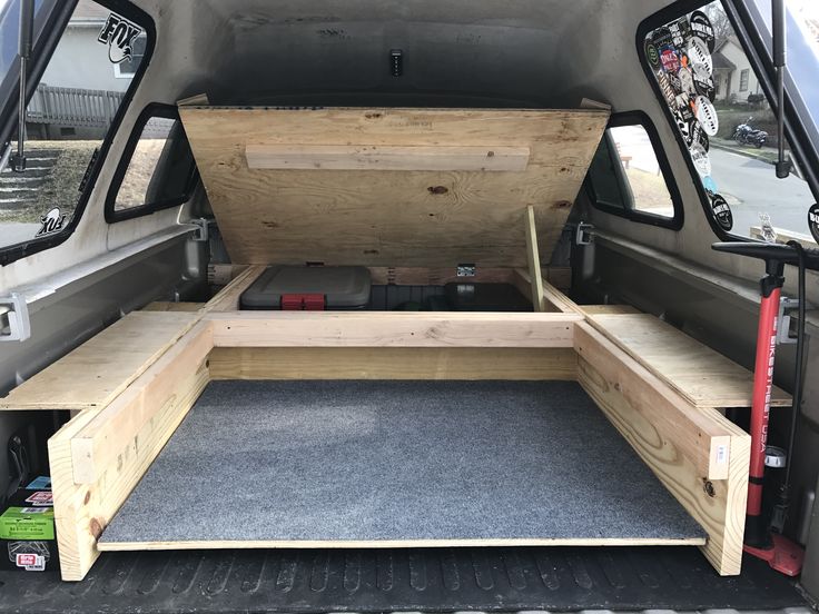 the back end of a van with an open hatchback and storage area in it