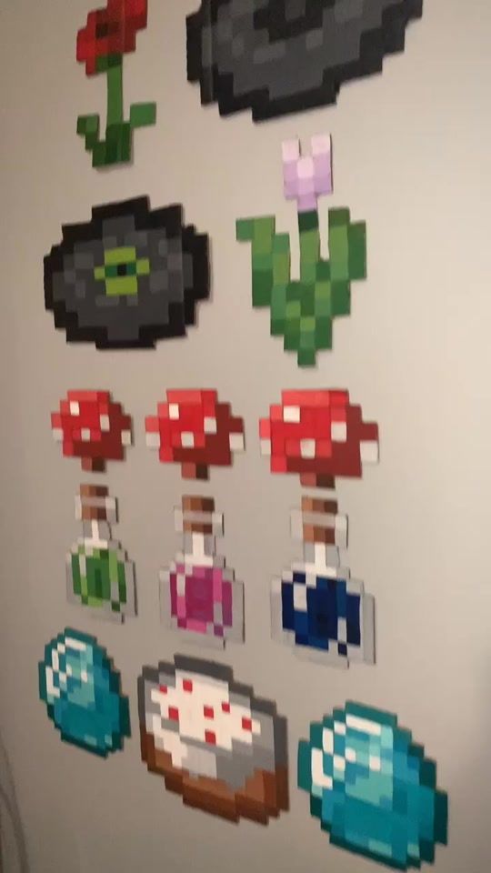 the pixel art is hanging on the wall in the room with it's decorations