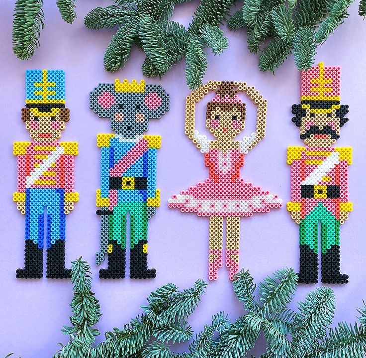 the pixel art is made to look like they are in different costumes and outfits, with pine branches around them