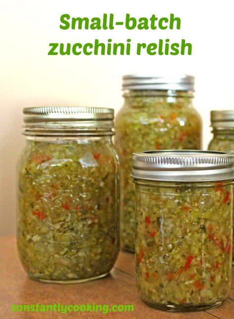 small batch zucchini relish in glass jars on a table with text overlay