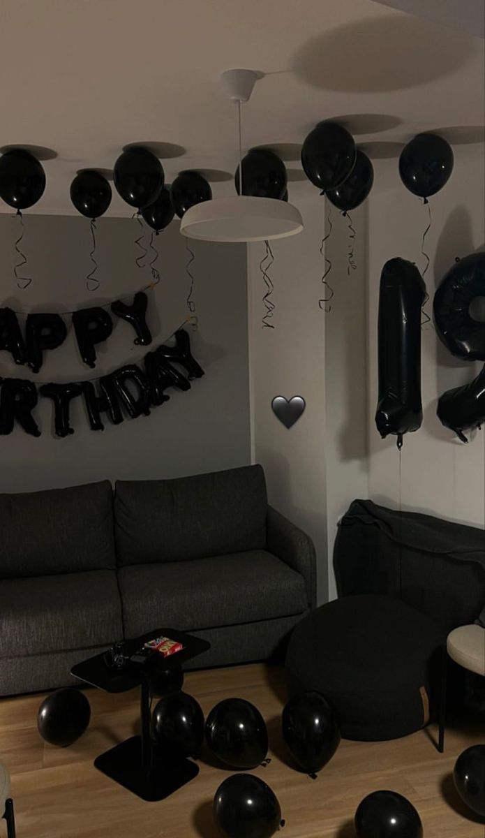 a living room filled with black and white balloons