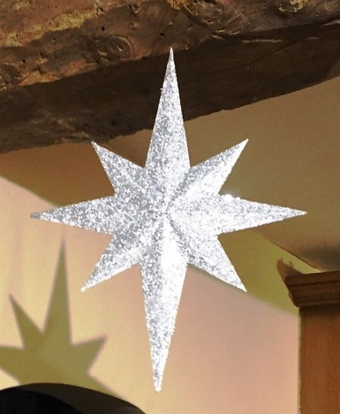 a white snowflake hanging from the ceiling