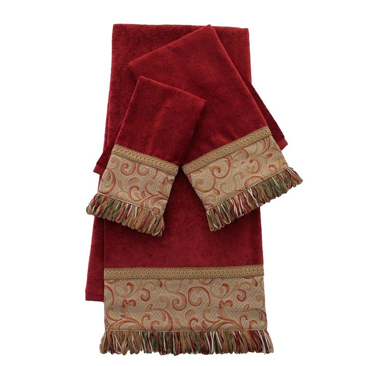 two red towels with fringe trims on top of each towel, one in gold and the other in maroon