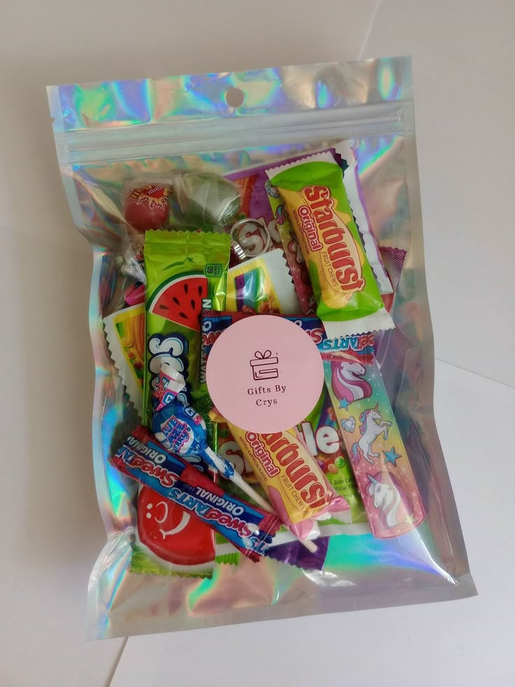 a bag filled with assorted candy on top of a table