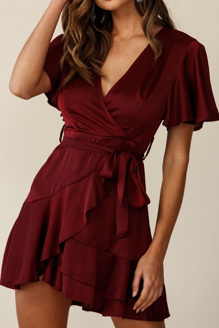 Hey pretty lady, you're causing quite the commotion in our sweet, sexy and silky Cami dress! Featuring a faux wrap skirt, separate ribbon belt, on-trend ruffle hemline, fluttery angel sleeves and invisible zipper closure. Team it with delicate gold jewelry and nude heels and sashay your way across the dance floor, right in front of that hottie who's been staring at you all night. MODEL INFOModel is wearing size XSHeight: 5'8"Bust: 34"Waist: 23"Hips: 34"Size Guide CAREHand Wash Cold. Do Selfie Leslie, Ice Dresses, Angel Sleeve, Faux Wrap Dress, Cami Dress, Wrap Skirt, Fit & Flare, Red Dress, Chic Style