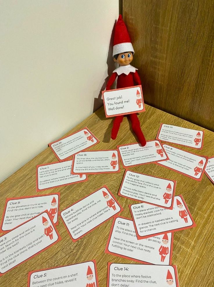 an elf is sitting on the table with some cards