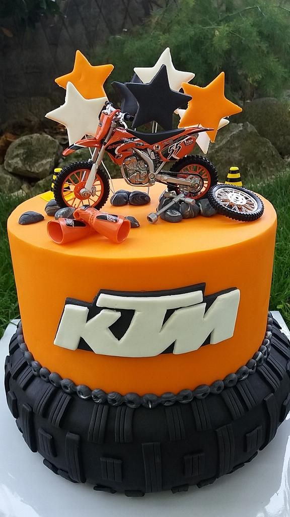 an orange motorcycle cake with stars on top