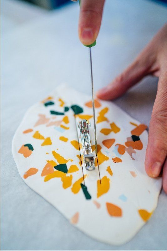 a person is working on some art with scissors and paintbrushes to make an ornament