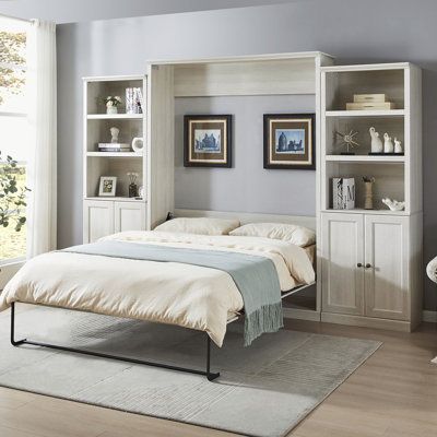 a bedroom with a bed, bookshelf and chair next to a large window