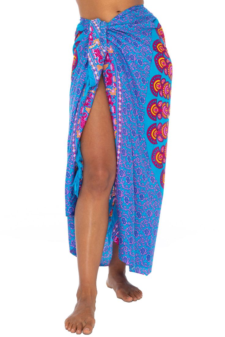 Brilliantly exotic, this sexy, lightweight beach sarong lures admiring eyes with its stunning peacock design. A mandala of painted feathers ripples out from the center, giving you every reason to strut your beauty by beach or poolside. Just cinch to fit with the coconut shell buckle to wear as a sarong dress, wrap skirt, bathing suit cover up or night-out shawl. Or use it to makes waves on the beach or at home as a lightweight blanket or tablecloth. Back From Bali is dedicated to creating beautiful, quality clothing with a heart. All of our items are crafted, sewn and painted by hand in Bali, by local artists and women who own small home businesses. For over 20 years, we have nurtured fair, honest and caring relationships with our artisans and their families – so you can feel as good about Multicolor Bohemian Sarong For Festivals, Bohemian Multicolor Sarong For Festivals, Multicolor Bohemian Sarong With Vibrant Print, Red Bohemian Sarong For Festivals, Bohemian Multicolor Sarong With Vibrant Print, Bohemian Multicolor Vibrant Print Sarong, Skirt Bathing Suit, Circular Mandala, Shell Clip