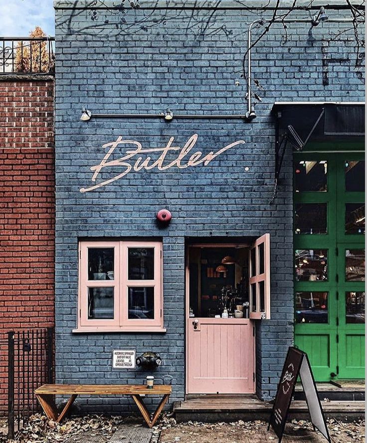 an instagram page with a photo of a blue brick building and green front door