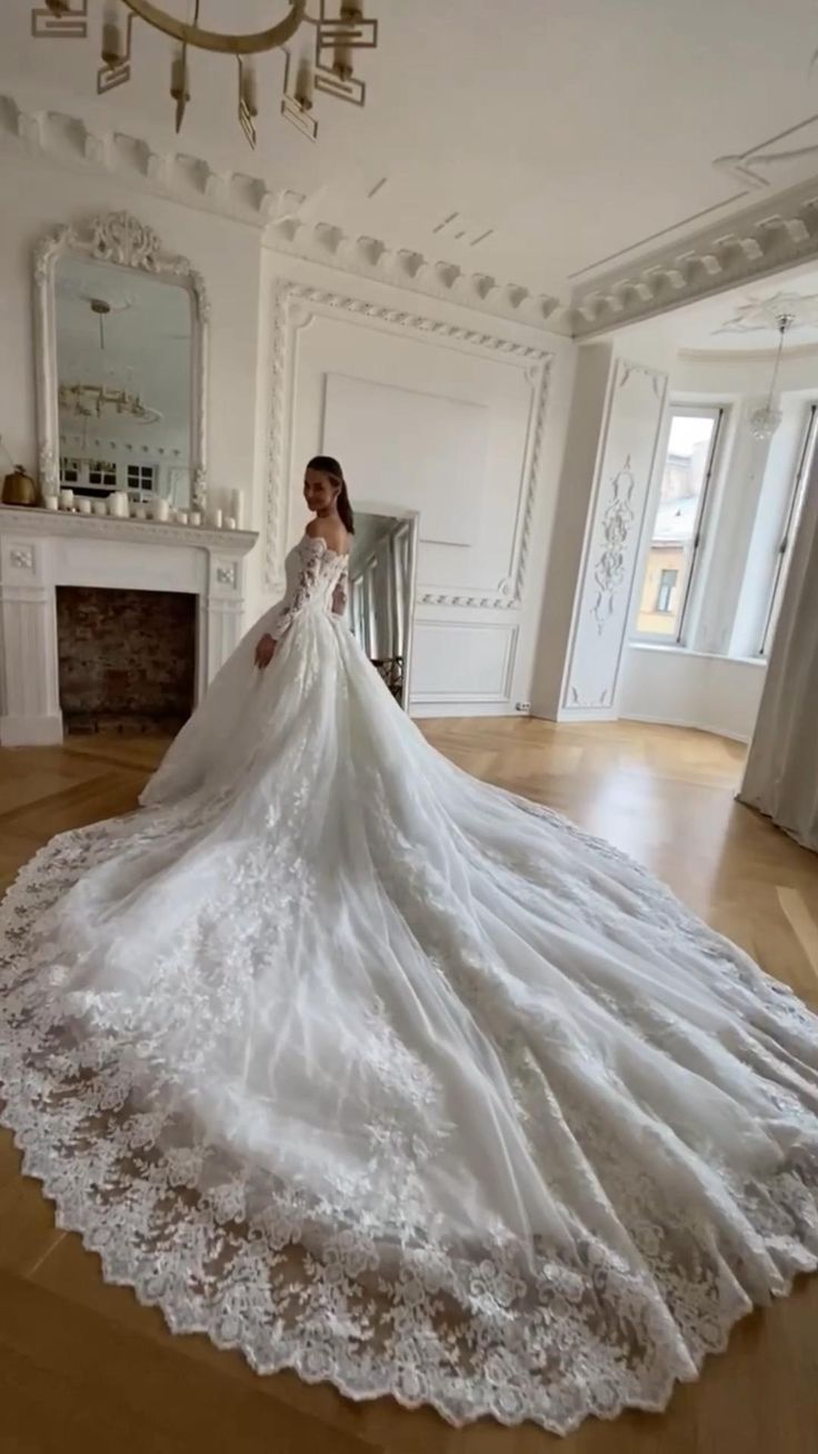 a woman in a wedding dress standing on the floor