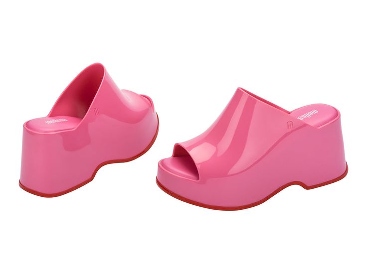 Throwback style meets current trends—that’s just how the Patty rolls. Lightweight and streamlined with a wide strap and a peep toe, these platform mules are true attention seekers, and the contrasting sole detail amps up the cool factor. Made from our revolutionary Melflex® PVC plastic, you enjoy more flexibility and comfort. Plus, they’re 100% recyclable. Chic Mules With Red Sole, Trendy Platform Slip-on Slides, Trendy Round Toe Slides For Spring, Chic Platform Slide Slippers, Modern Pink Open Toe Slides, Trendy Chunky Platform Slide Sandals, Trendy Open Heel Synthetic Slides, Modern Open Toe Platform Slippers, Pink Spring Mules With Rubber Sole