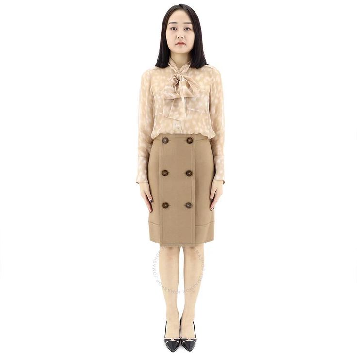 Luxuriously soft Burberry skirt combines premium wool, cashmere and delicate detailing. Warm camel hue flatters all. Detachable buttoned panel added flair for every occasion whether brunch or event. Comfortable A-line silhouette falls at knee for effortless style. Wear with boots now, sandals as temps rise. Investment piece you'll reach for season after season. Classic Workwear Mini Skirt With Button Closure, Classic Mini Skirt With Button Closure For Work, Chic Buttoned Pencil Skirt For Work, Chic Pencil Skirt With Buttons For Workwear, Chic Workwear Pencil Skirt With Buttons, Spring Office Mini Skirt With Button Closure, Office Pencil Skirt With Button Closure, Buttoned Pencil Mini Skirt For Work, Spring Mini Skirt With Button Closure For Work