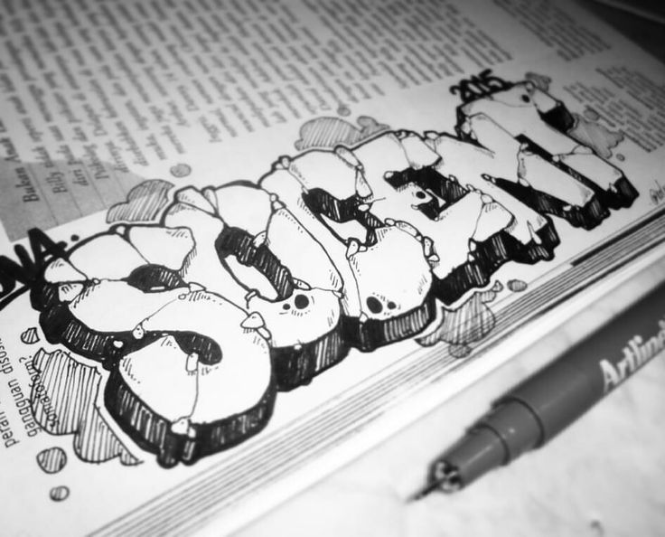 the word graffiti is drawn in black and white ink on top of an open book