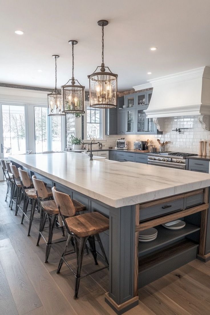 a large kitchen with an island in the middle and lots of chairs on the side