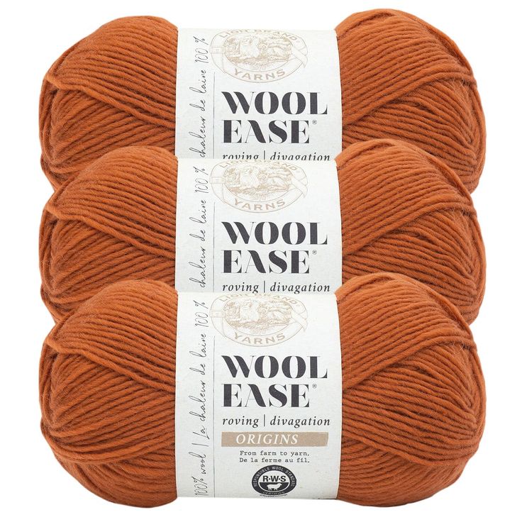 three skeins of wool - ease yarn in orange