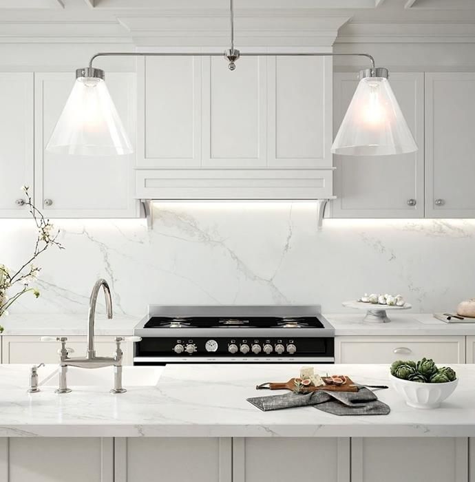 an image of a kitchen setting with white cabinets and marble counter tops on the website page