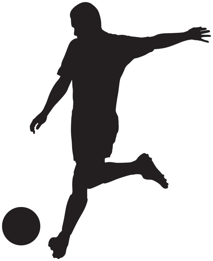 a silhouette of a man kicking a soccer ball